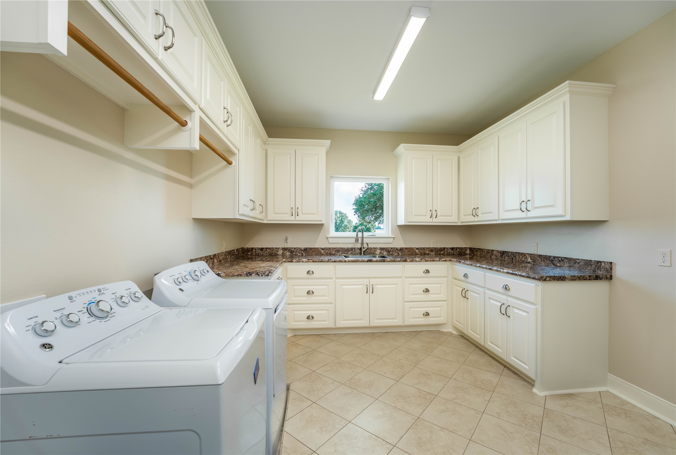 1470 South Nassau Road Round Top, TX 78954 - Photo 19 of 30 a kitchen with granite countertop white cabinets sink and white appliances