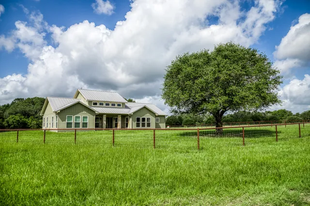 a front view of a house with a big yard