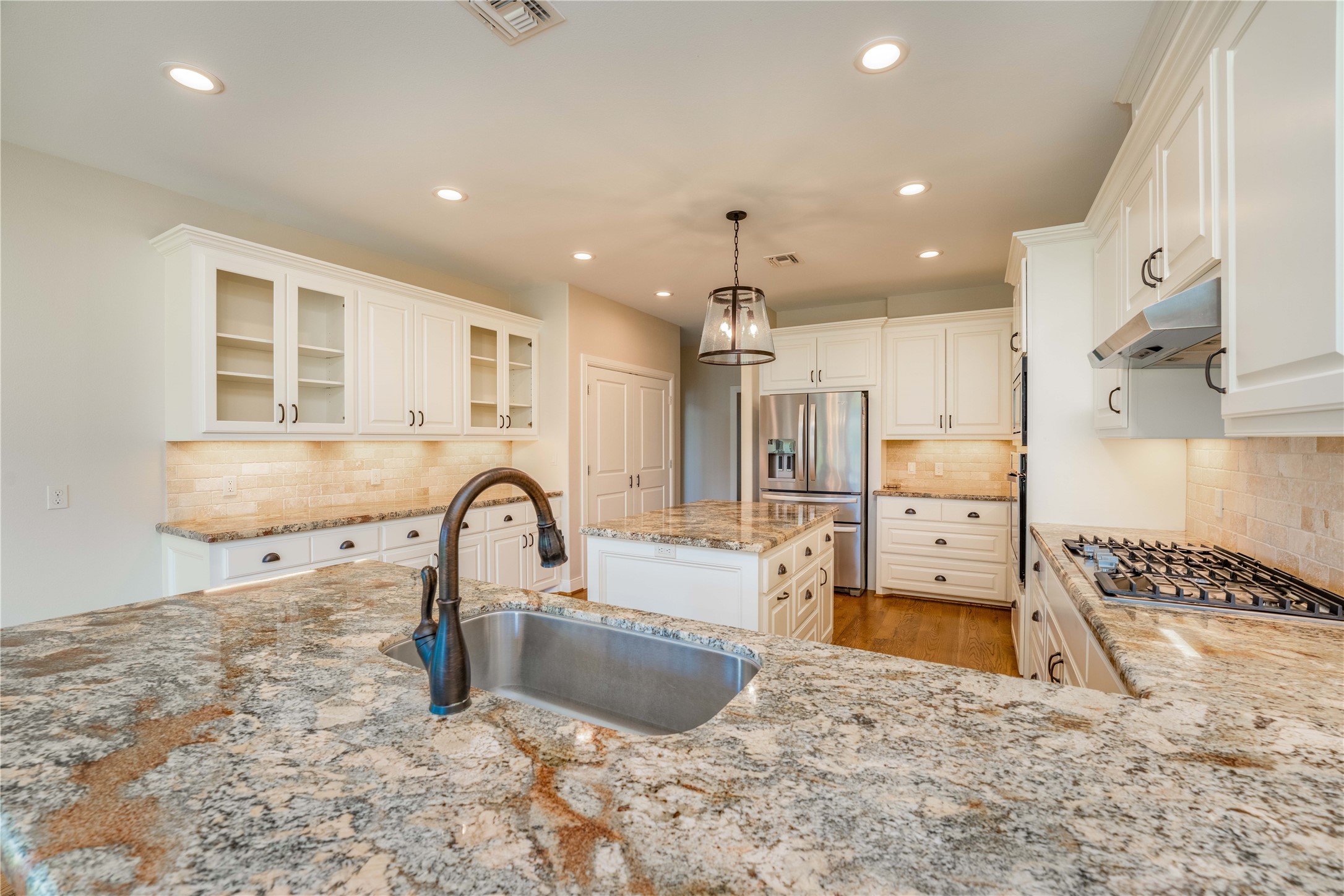 1470 South Nassau Road Round Top, TX 78954 - Photo 7 of 30 a kitchen with kitchen island granite countertop a sink and a refrigerator