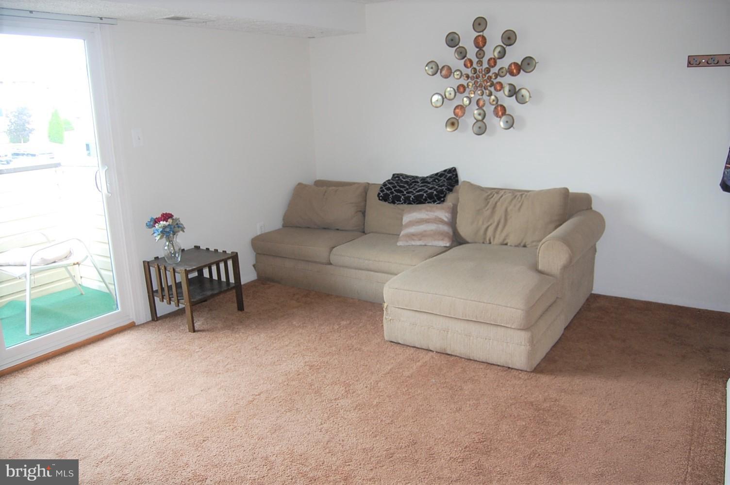 19501 Gunners Branch Road, Unit M Germantown, MD 20876 - Photo 3 of 11 a living room with furniture and a large window