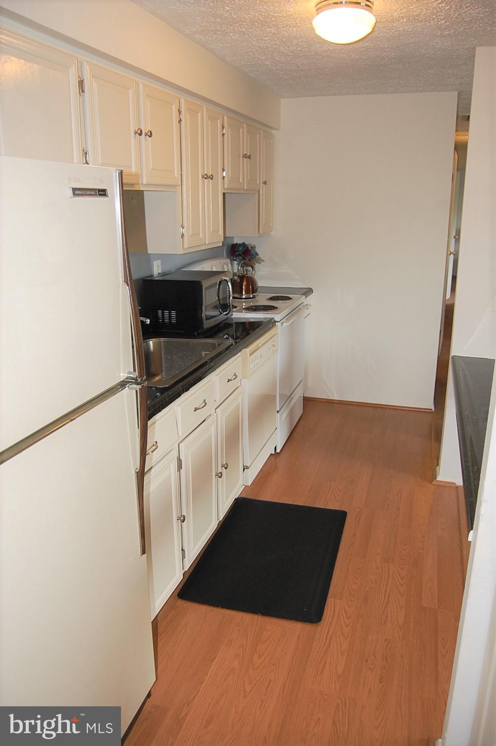 19501 Gunners Branch Road, Unit M Germantown, MD 20876 - Photo 4 of 11 a kitchen with a sink and cabinets