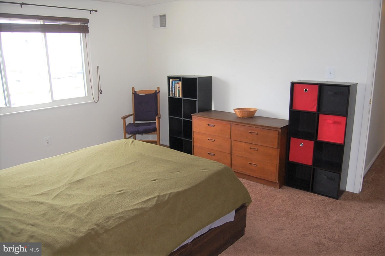 19501 Gunners Branch Road, Unit M Germantown, MD 20876 - Photo 8 of 11 a bedroom with a bed and wooden floor