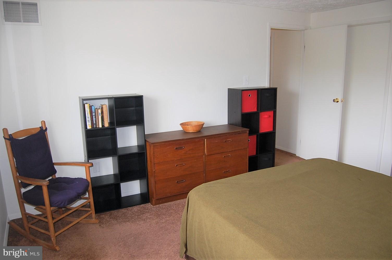 19501 Gunners Branch Road, Unit M Germantown, MD 20876 - Photo 9 of 11 a bed room with a bed and a chair