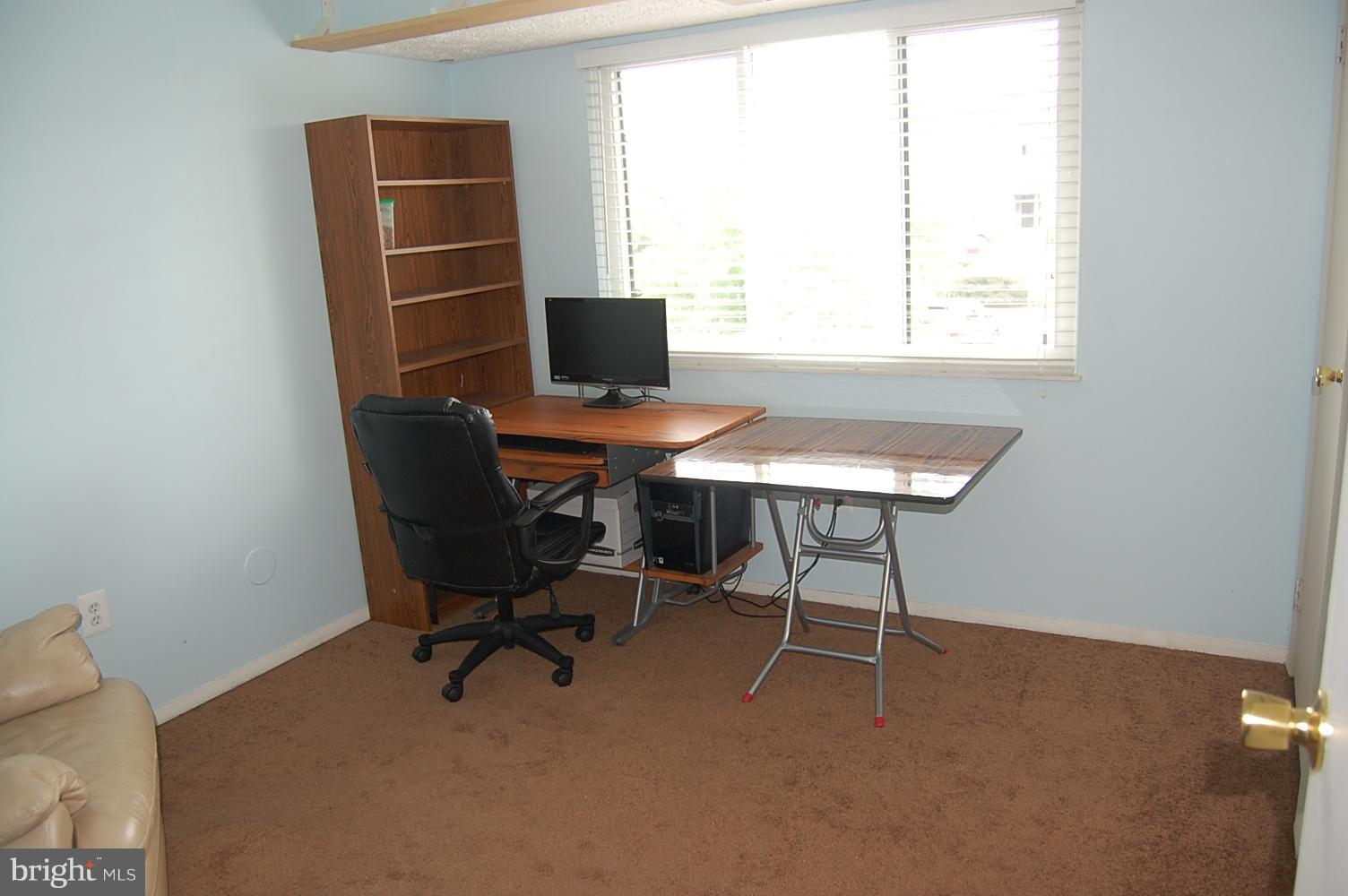 19501 Gunners Branch Road, Unit M Germantown, MD 20876 - Photo 10 of 11 a view of a workspace with furniture and a window