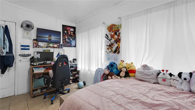 a bedroom with a bed and a tv