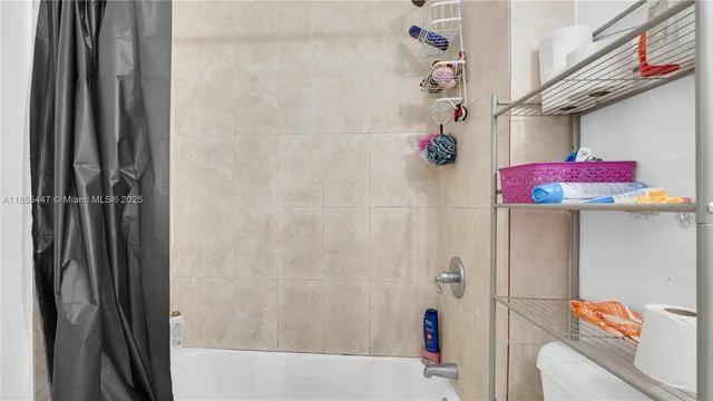 a bathroom with a shower and a sink