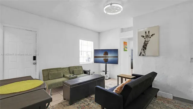 a living room with furniture and a blue wall