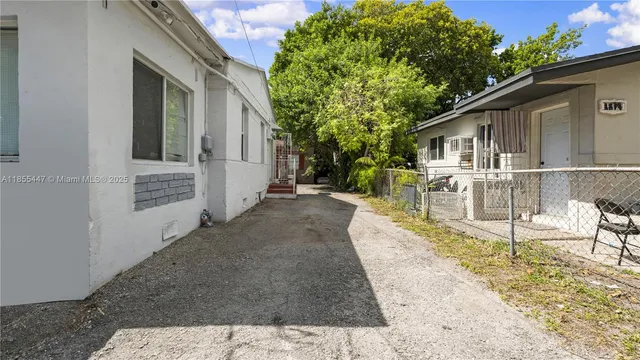 a view of a house with backyard and sitting area