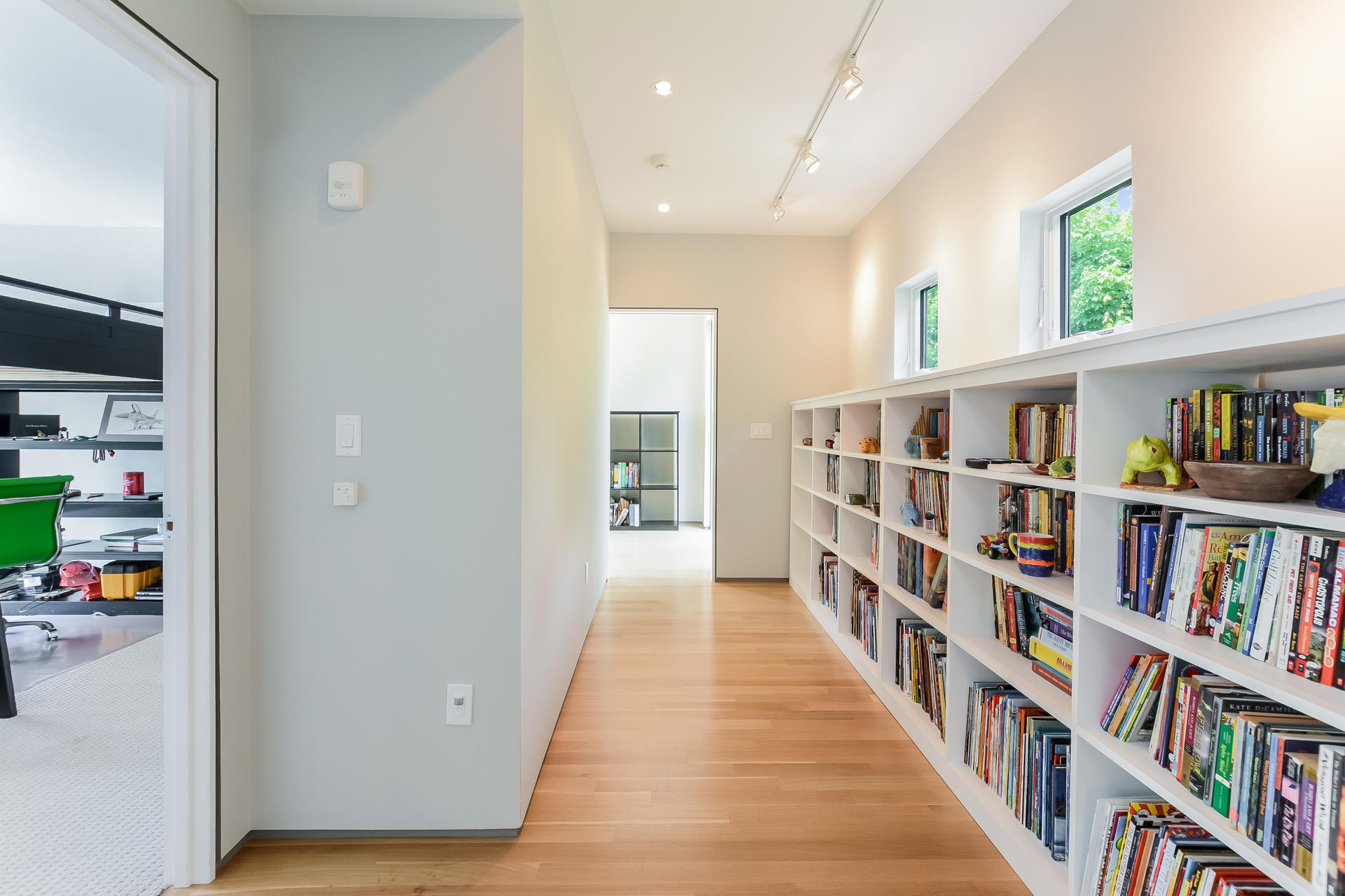 37 The Hunt Circle Mashpee, MA 02649 - Photo 38 of 73 a hallway with wooden floor and book shelf