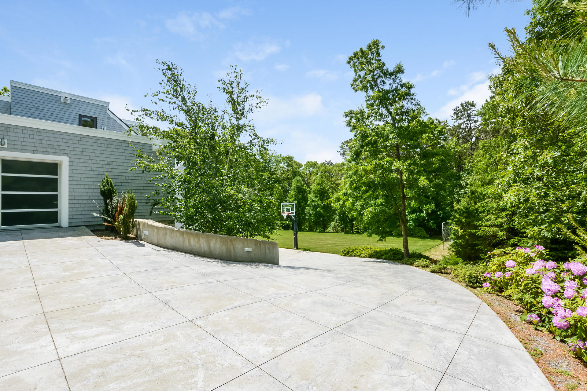 37 The Hunt Circle Mashpee, MA 02649 - Photo 57 of 73 a view of a backyard with potted plants and a fountain