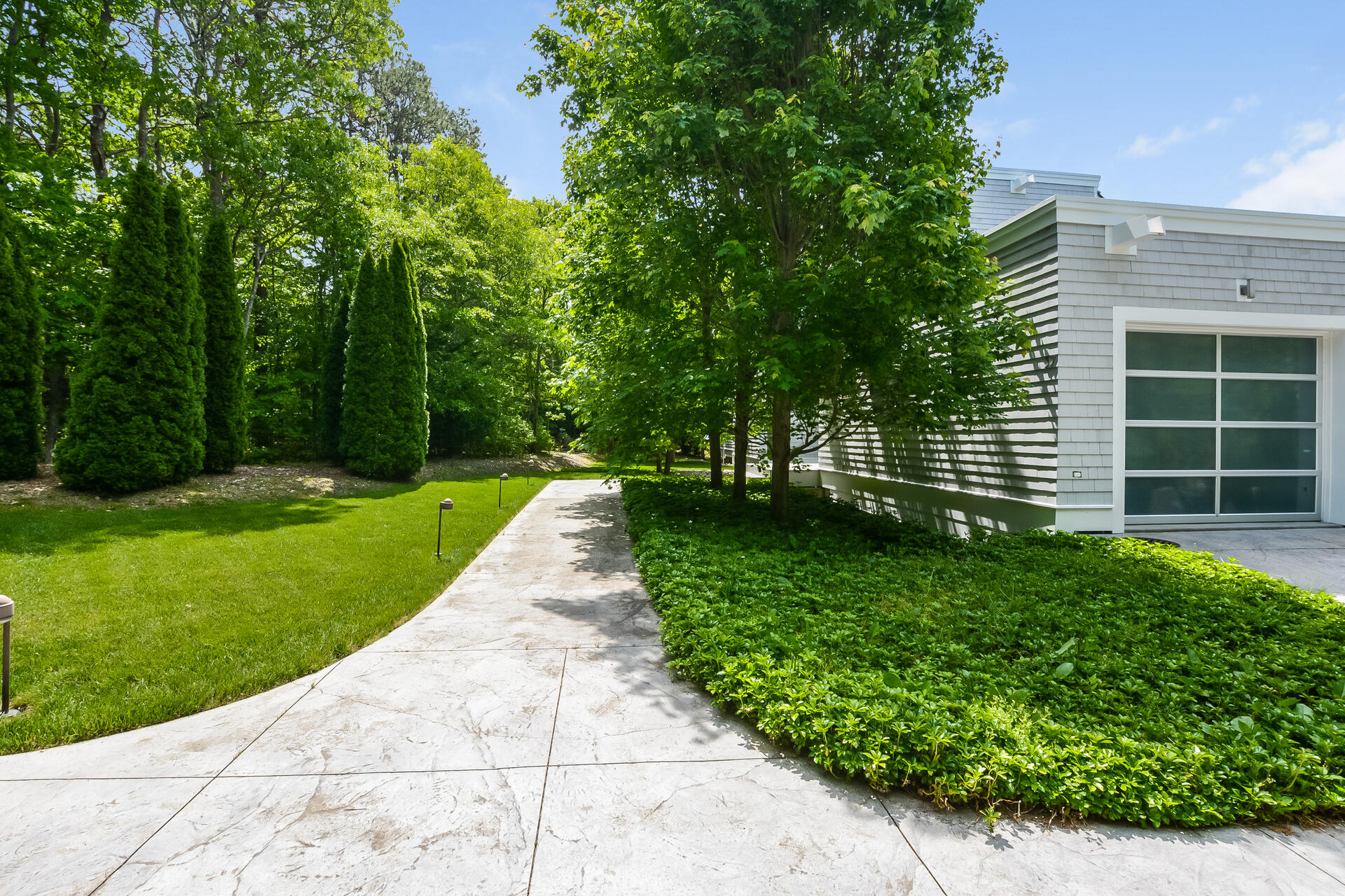 37 The Hunt Circle Mashpee, MA 02649 - Photo 60 of 73 a view of a backyard with potted plants and large trees