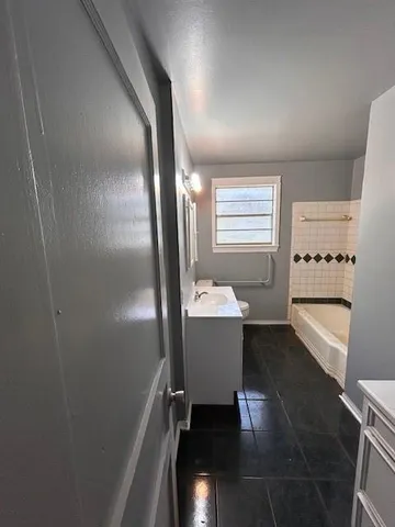 a view of a bathroom with bathtub and window