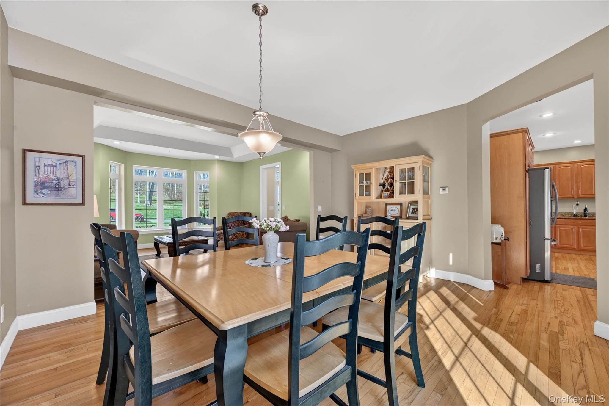 47 Willets Way Newburgh, NY 12550 - Photo 17 of 50 a view of a dining room and livingroom with furniture wooden floor a chandelier