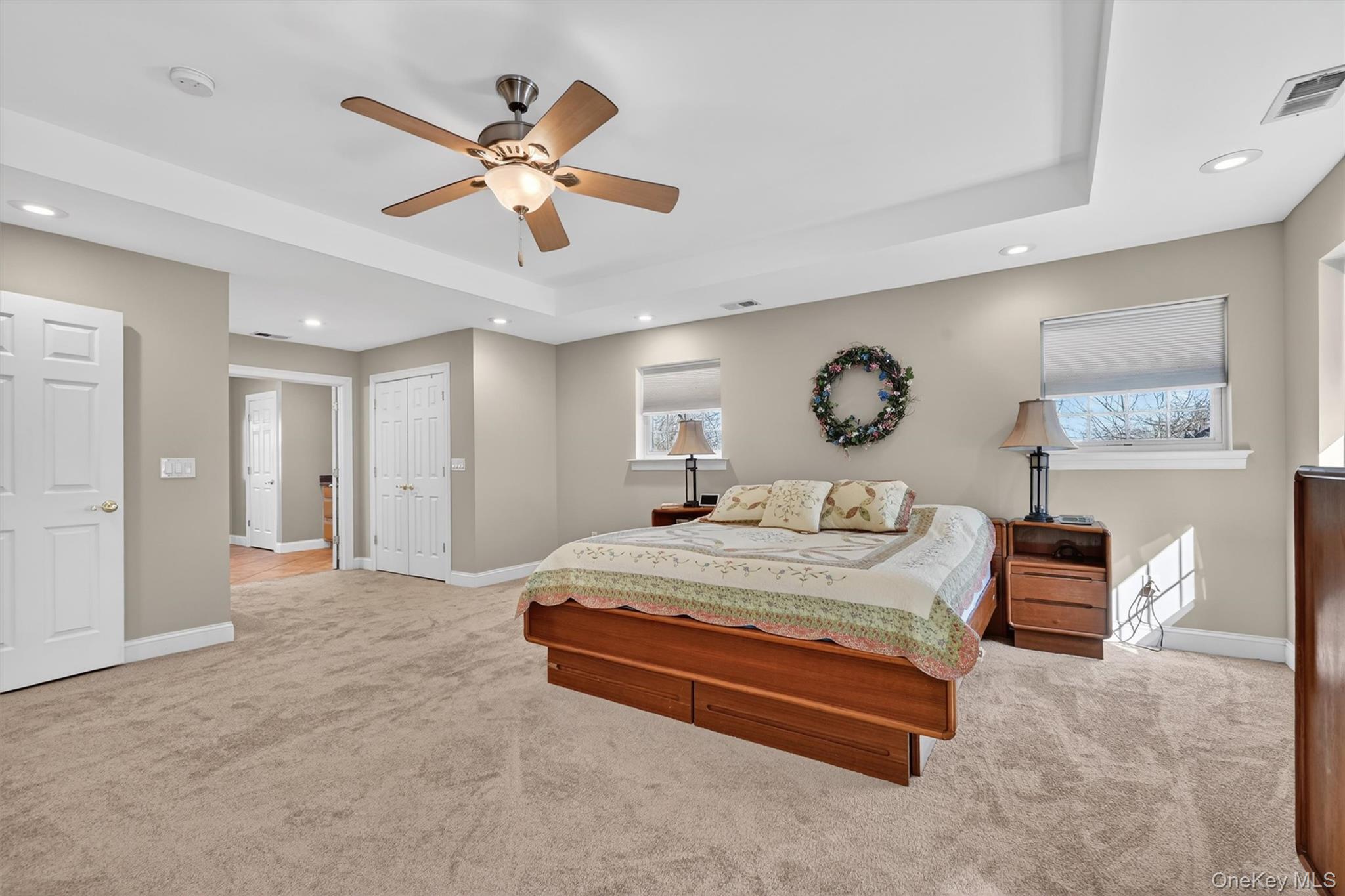 47 Willets Way Newburgh, NY 12550 - Photo 32 of 50 a spacious bedroom with a bed and a chandelier