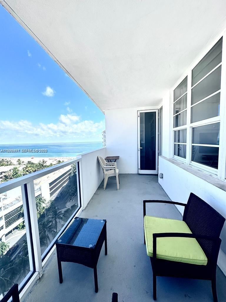 100 Lincoln Road, Unit 1404 Miami Beach, FL 33139 - Photo 15 of 18 a living room with furniture and a fireplace