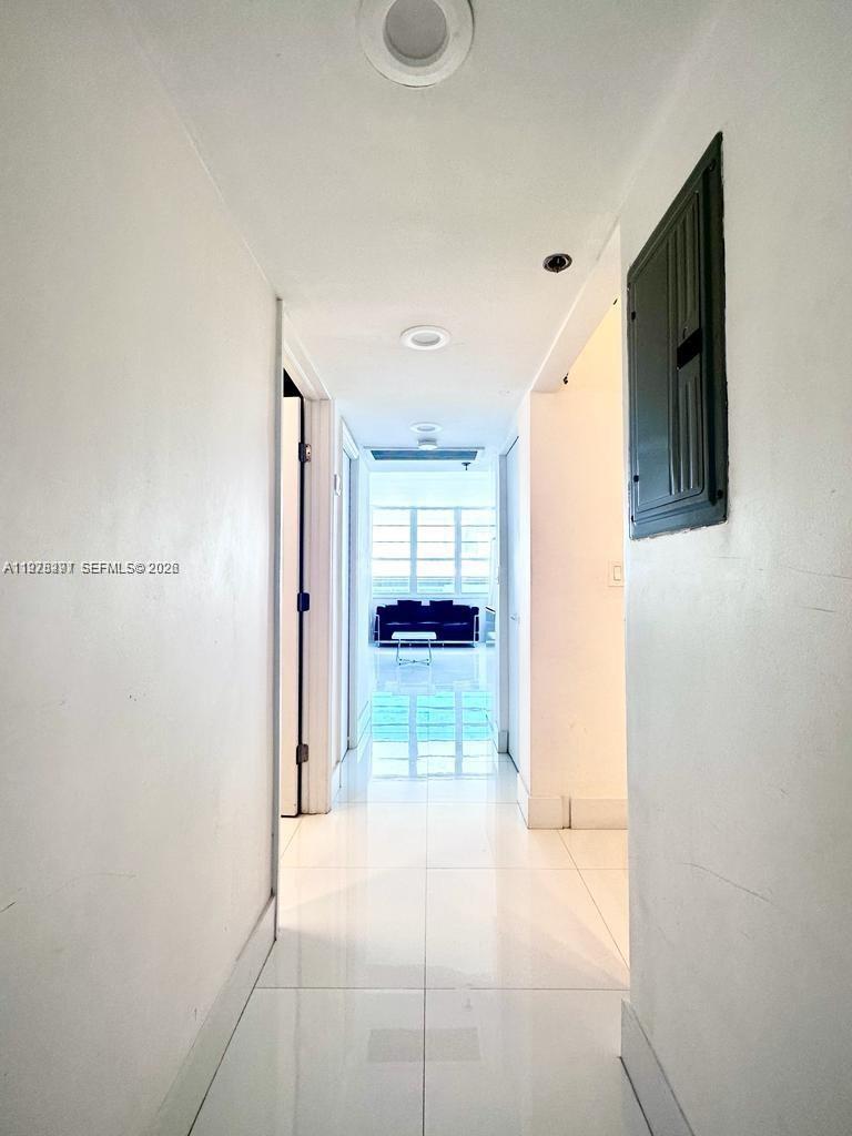 100 Lincoln Road, Unit 1404 Miami Beach, FL 33139 - Photo 18 of 18 a view of a hallway view of living room with wooden floor