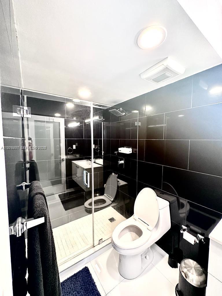 100 Lincoln Road, Unit 1404 Miami Beach, FL 33139 - Photo 2 of 18 a bathroom with a sink toilet and shower