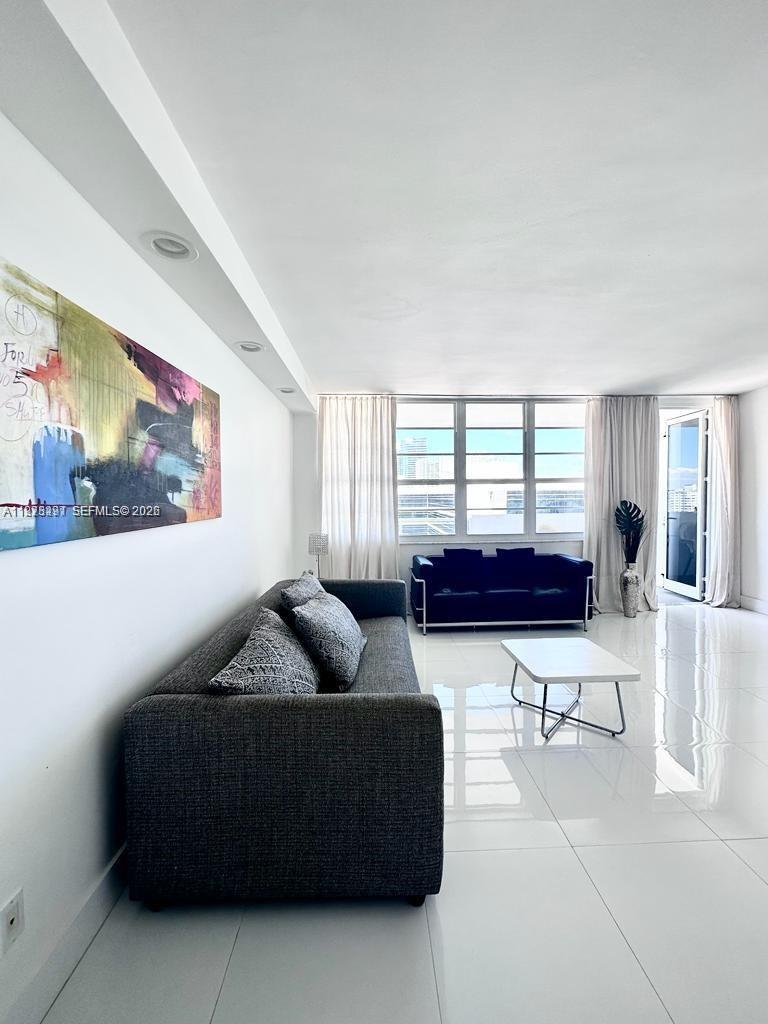 100 Lincoln Road, Unit 1404 Miami Beach, FL 33139 - Photo 3 of 18 a living room with furniture and a window