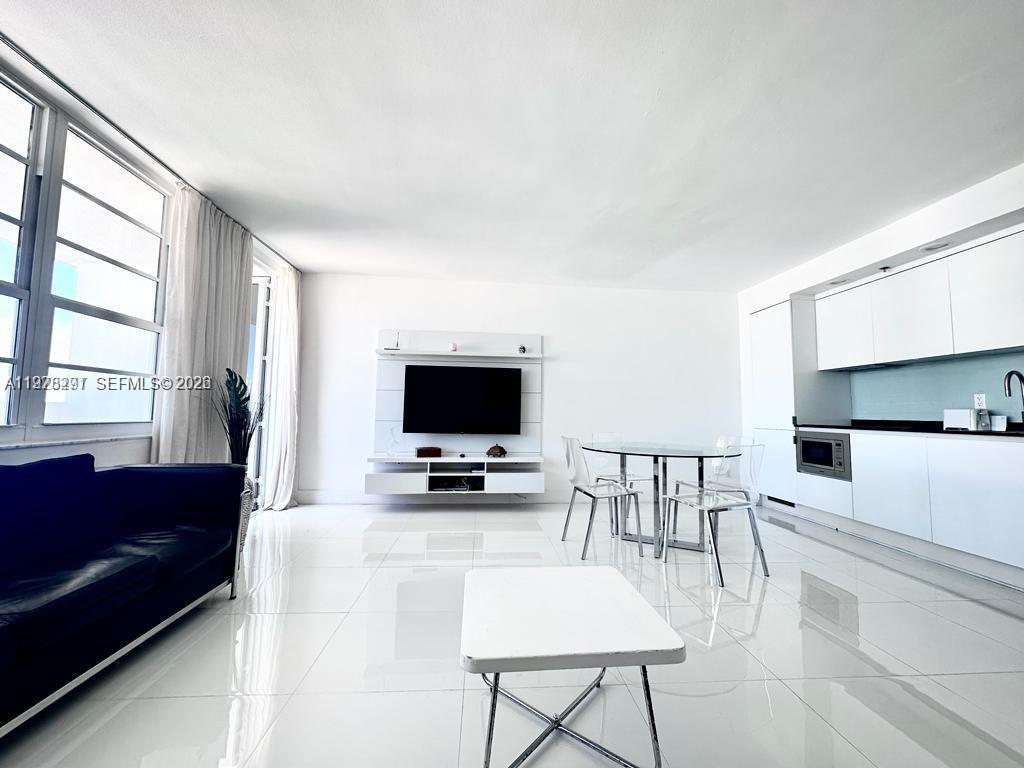 100 Lincoln Road, Unit 1404 Miami Beach, FL 33139 - Photo 4 of 18 a living room with furniture and a flat screen tv