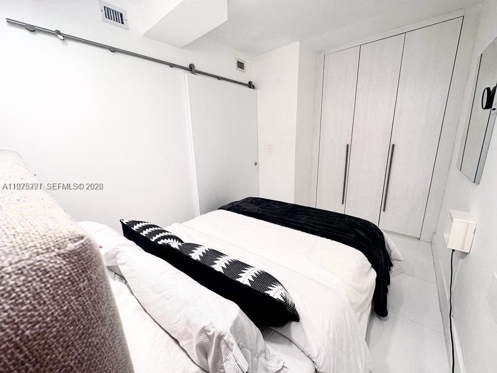 100 Lincoln Road, Unit 1404 Miami Beach, FL 33139 - Photo 7 of 18 a bedroom with a bed and a window