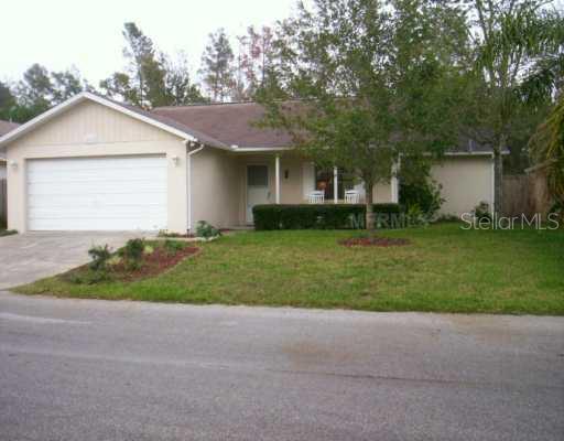 a front view of house with yard and green space