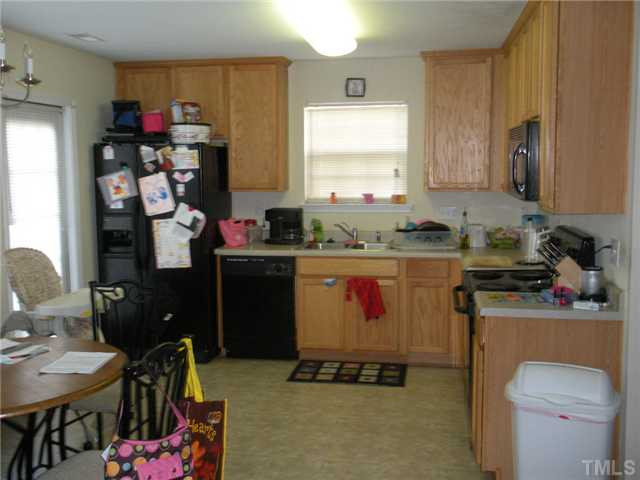 Kitchen with plenty of cabinet storage, built-in microwave, and access to the patio ... Kitchen