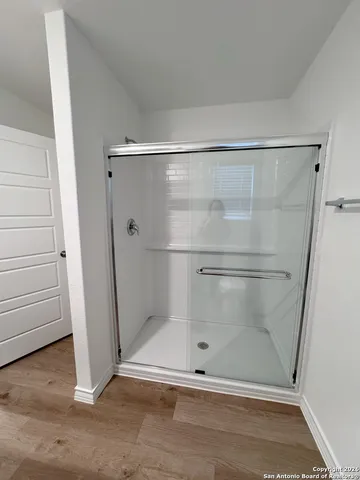 a bathroom with a glass door shower