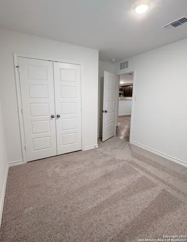 a view of an empty room and closet area