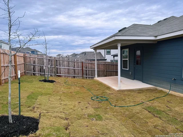 a view of a house with a backyard