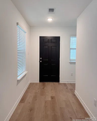 an empty room with windows and closet