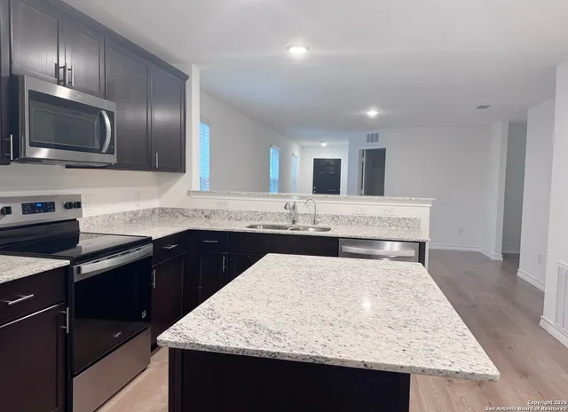 a kitchen with granite countertop counter top space appliances and cabinets