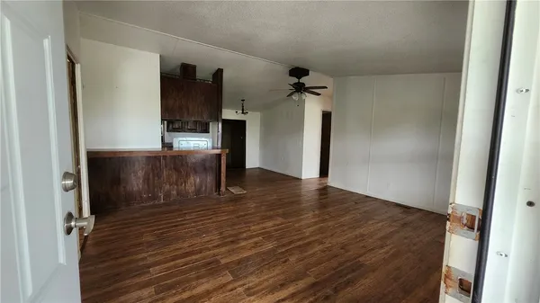 view of a field of grass and trees in the background