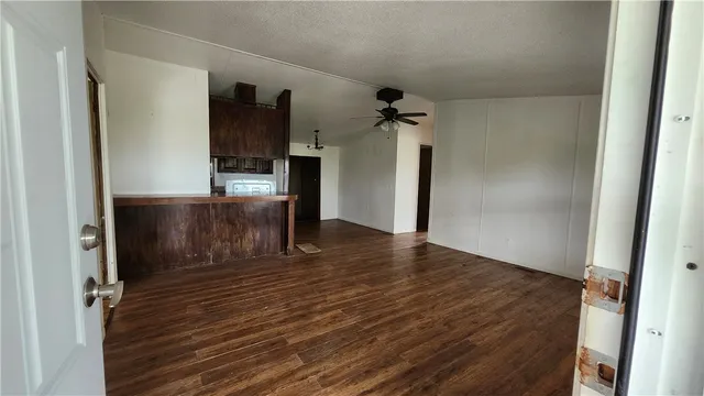 view of a field of grass and trees in the background