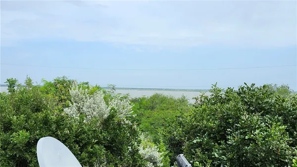 a view of a dirt road with a building in the background