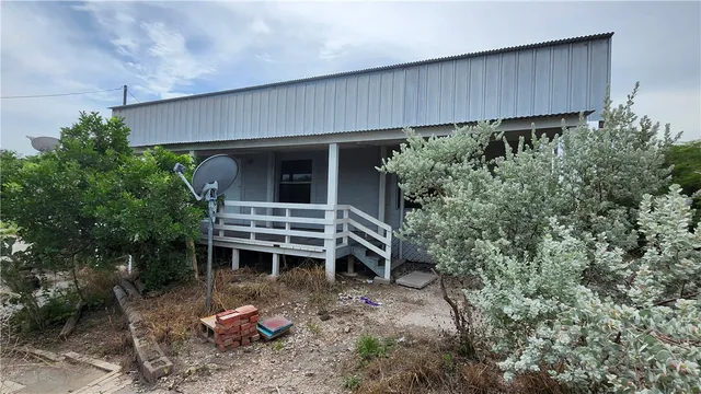 a backyard of a house with a yard and seating space