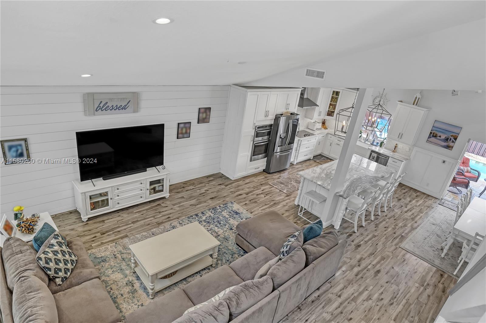 147 Stonebriar Boulevard Jupiter, FL 33458 - Photo 11 of 39 a living room with furniture and a flat screen tv