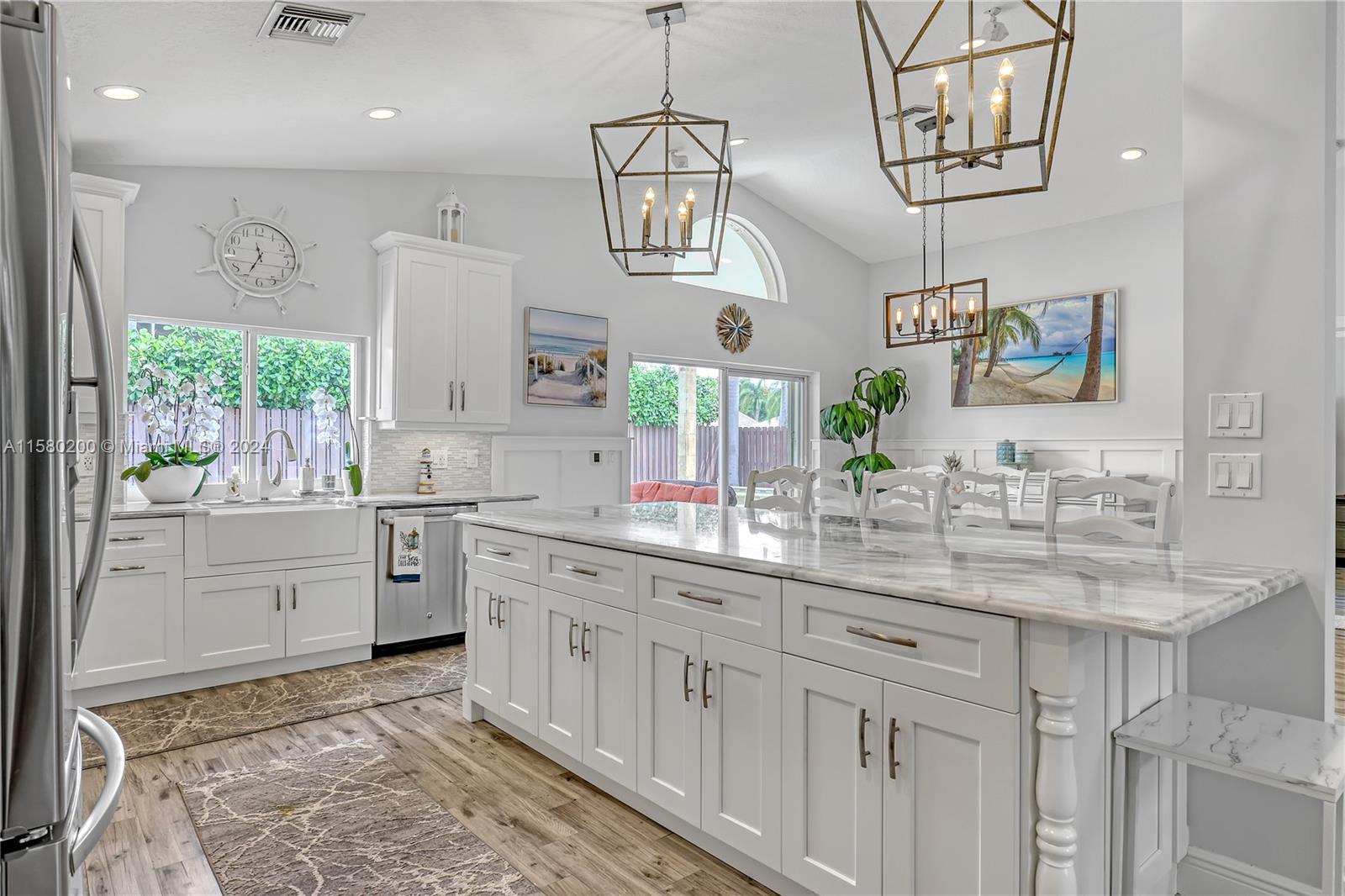 147 Stonebriar Boulevard Jupiter, FL 33458 - Photo 12 of 39 a large kitchen with a sink and cabinets