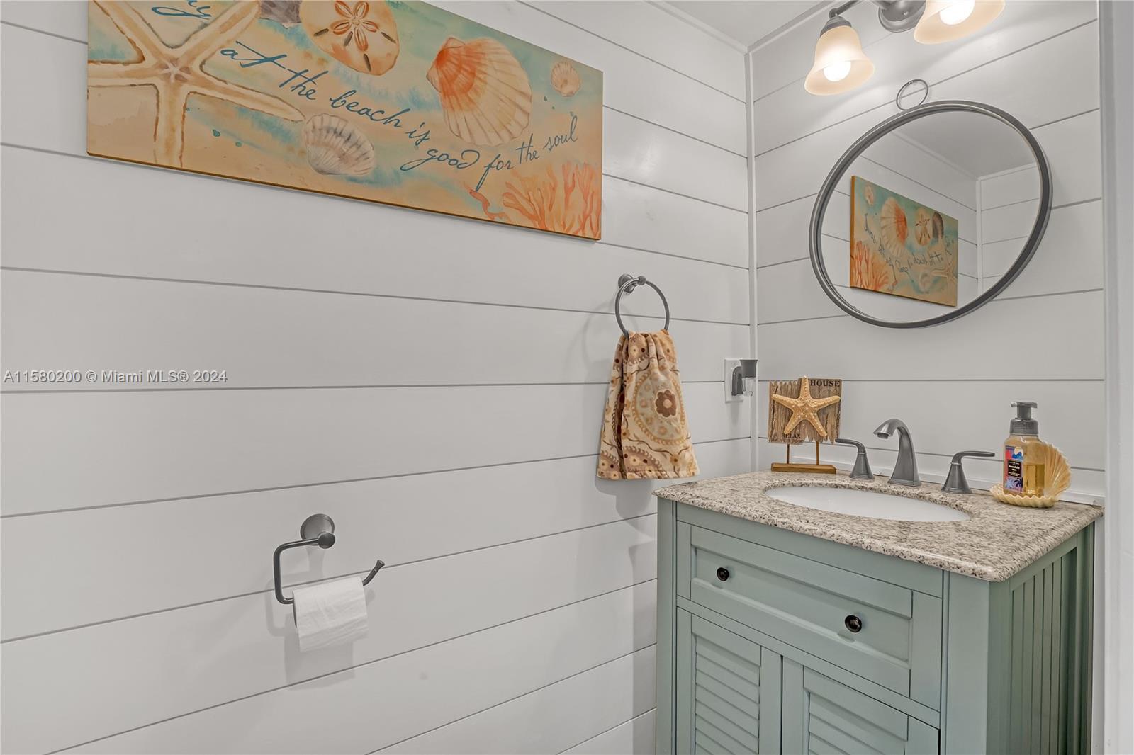 147 Stonebriar Boulevard Jupiter, FL 33458 - Photo 19 of 39 a bathroom with a sink and a mirror