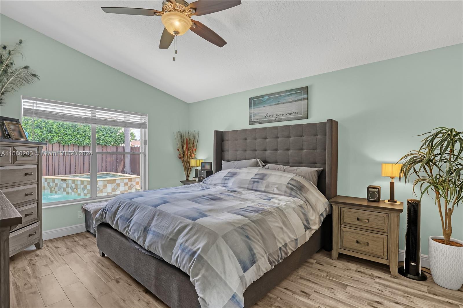 147 Stonebriar Boulevard Jupiter, FL 33458 - Photo 20 of 39 a bedroom with a bed and a window