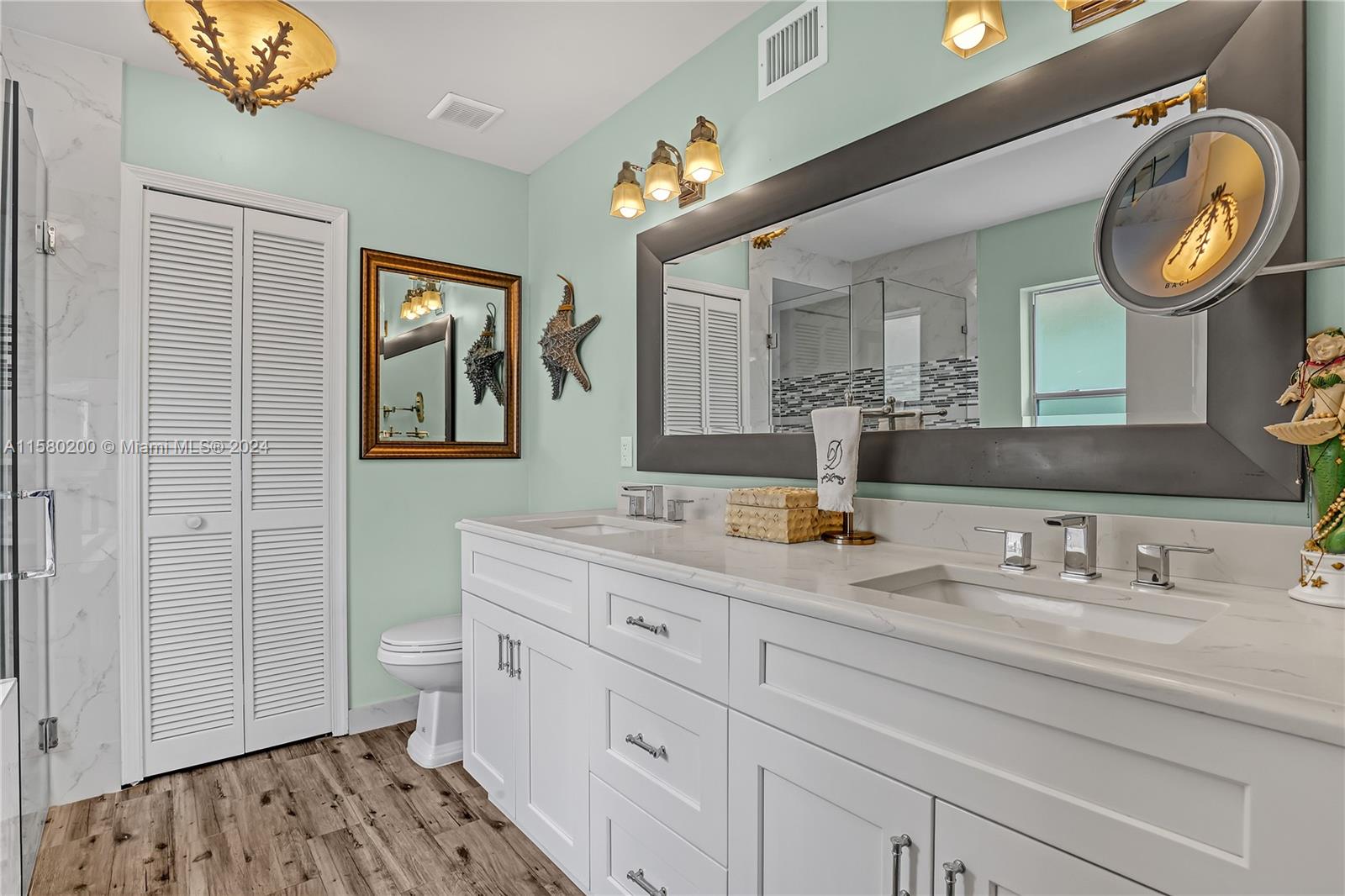147 Stonebriar Boulevard Jupiter, FL 33458 - Photo 22 of 39 a bathroom with a granite countertop double vanity sink and a mirror