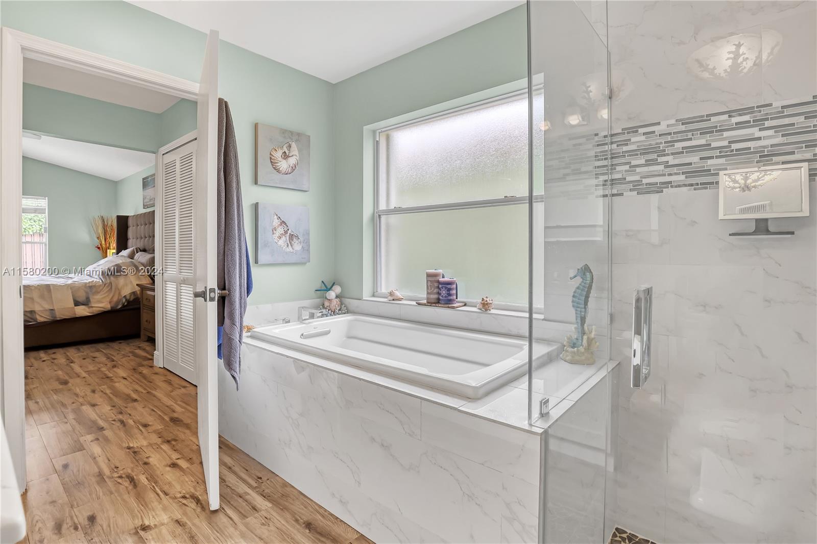 147 Stonebriar Boulevard Jupiter, FL 33458 - Photo 23 of 39 a en suite bathroom with a sink and a mirror