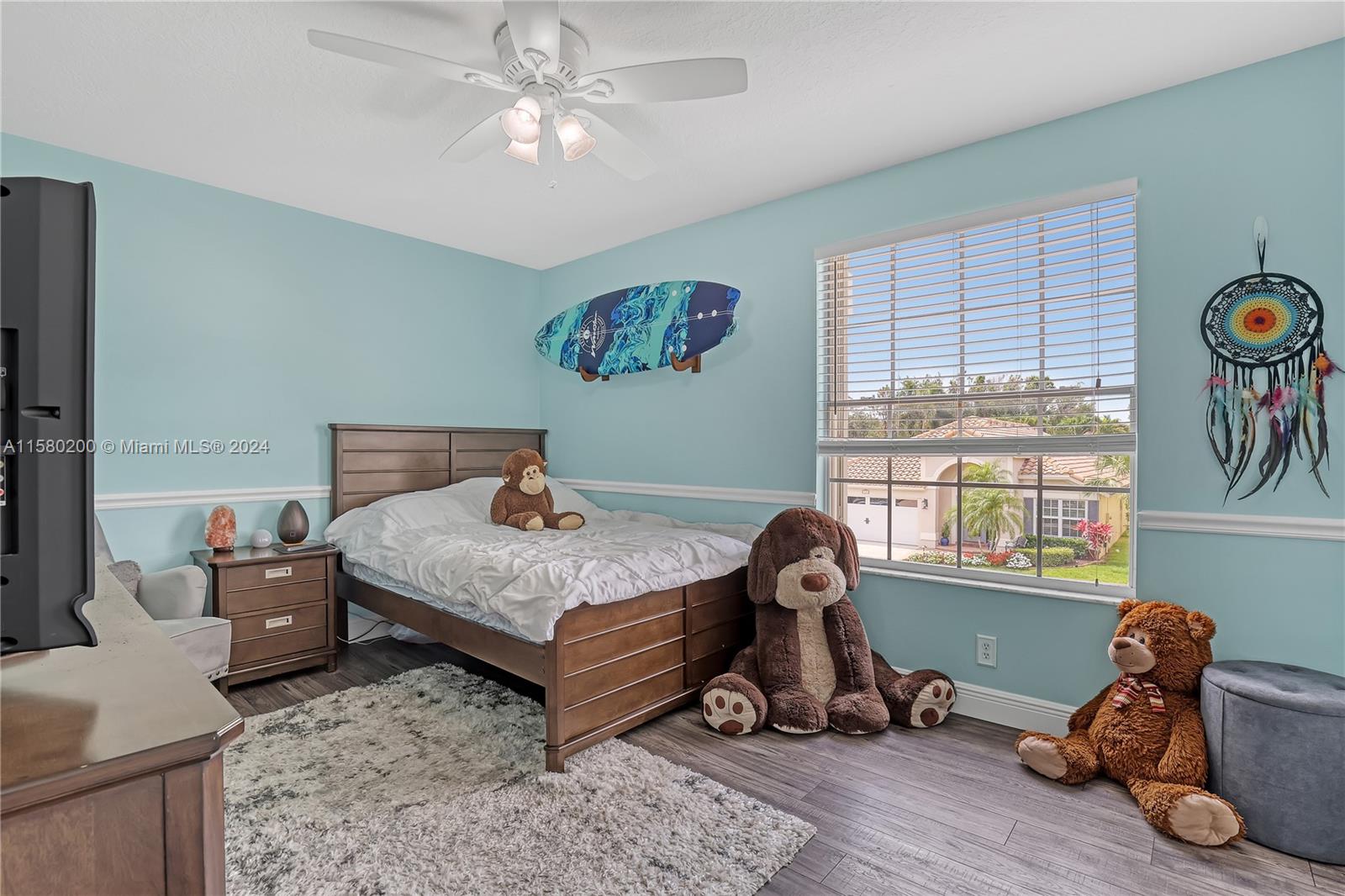 147 Stonebriar Boulevard Jupiter, FL 33458 - Photo 26 of 39 a bedroom with furniture and a window