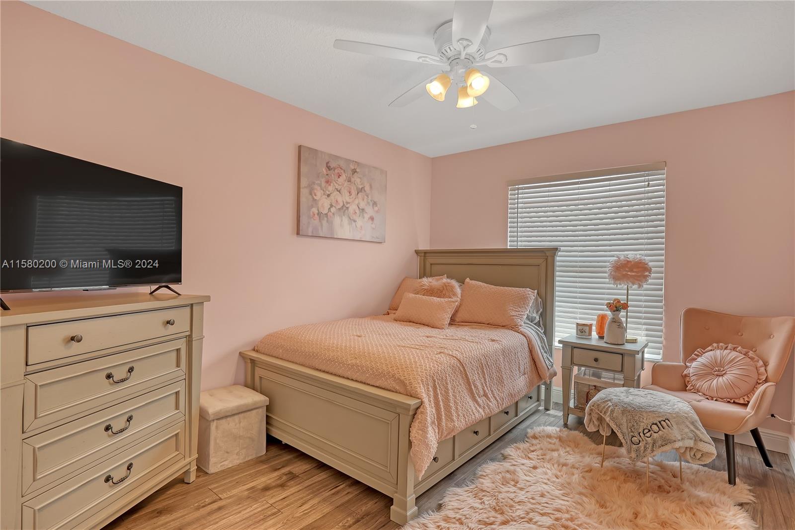 147 Stonebriar Boulevard Jupiter, FL 33458 - Photo 28 of 39 a bedroom with a bed and a flat screen tv