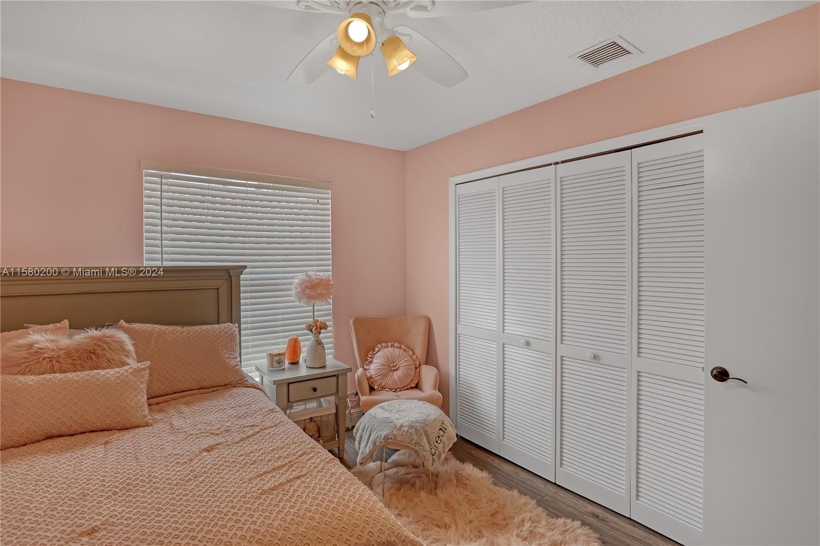 147 Stonebriar Boulevard Jupiter, FL 33458 - Photo 29 of 39 a bedroom with bed and a window