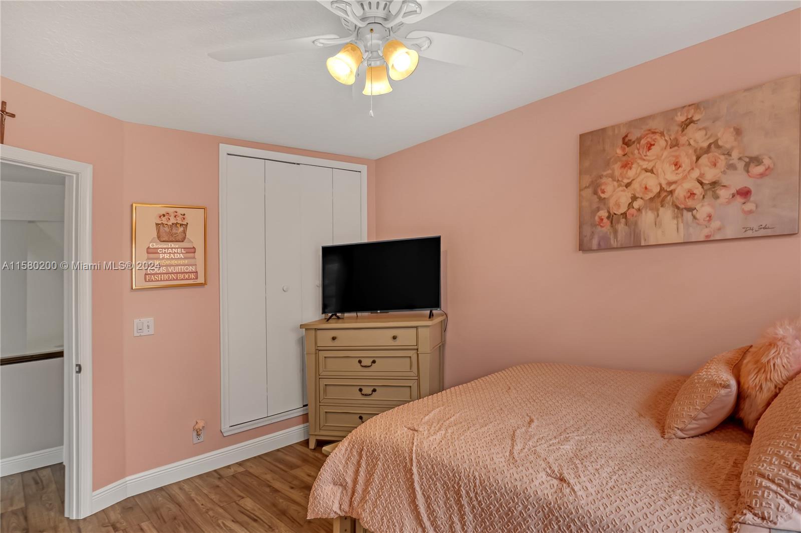 147 Stonebriar Boulevard Jupiter, FL 33458 - Photo 30 of 39 a bedroom with a bed and a flat screen tv