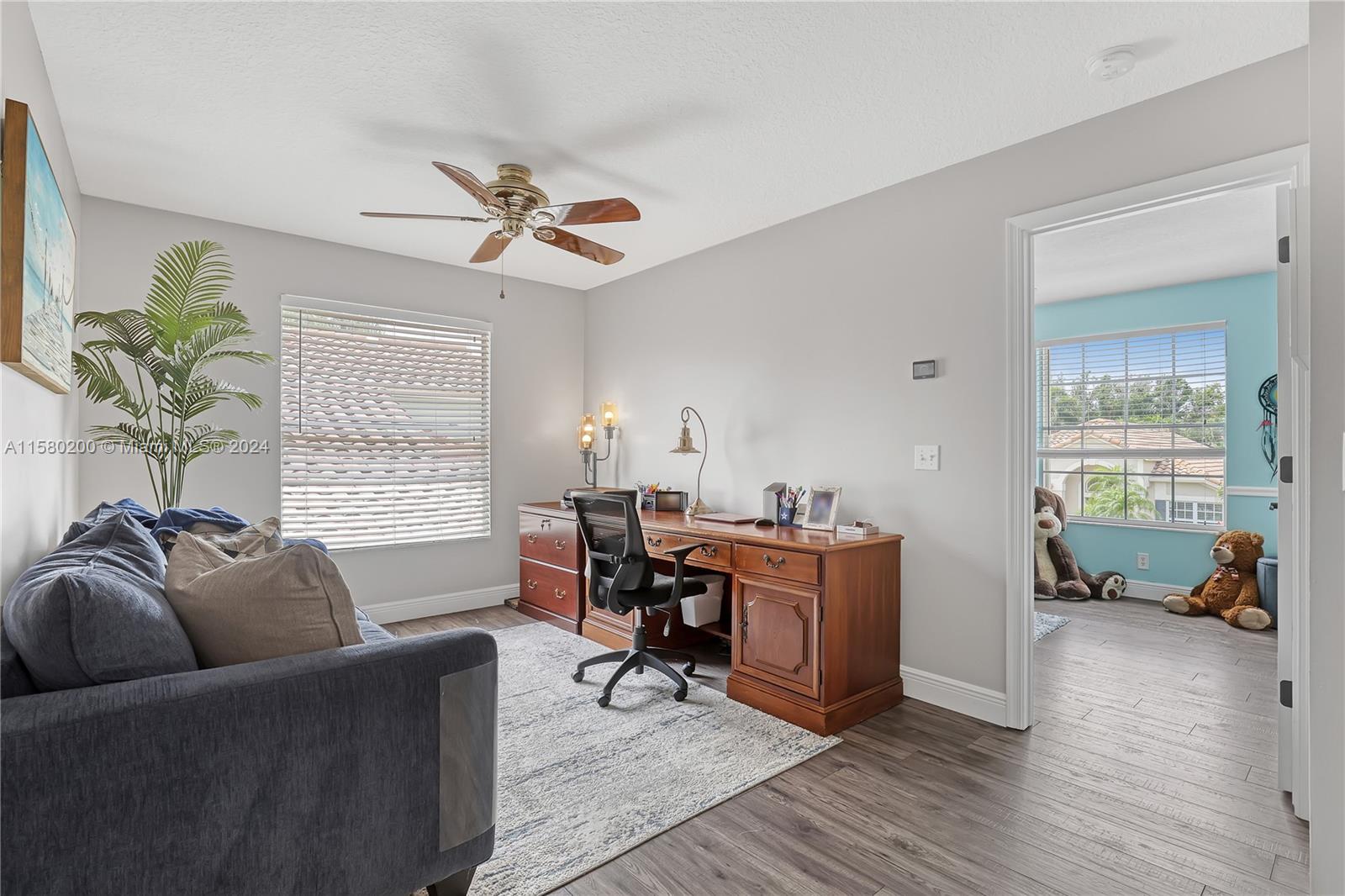147 Stonebriar Boulevard Jupiter, FL 33458 - Photo 33 of 39 a living room with furniture a window and a chandelier