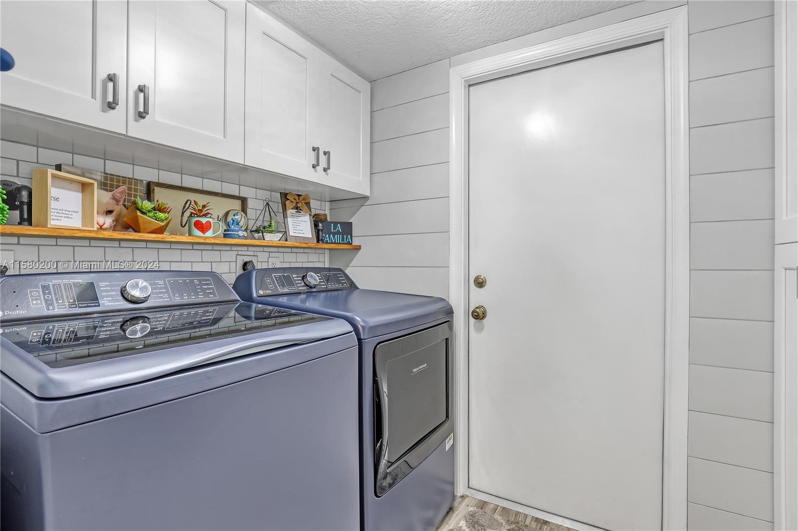 147 Stonebriar Boulevard Jupiter, FL 33458 - Photo 34 of 39 a utility room with dryer and washer