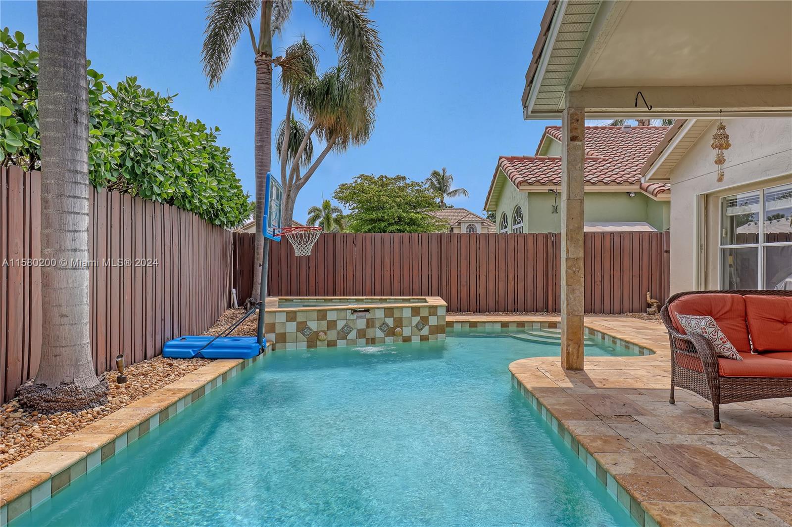 147 Stonebriar Boulevard Jupiter, FL 33458 - Photo 36 of 39 a view of a chair and table in the backyard