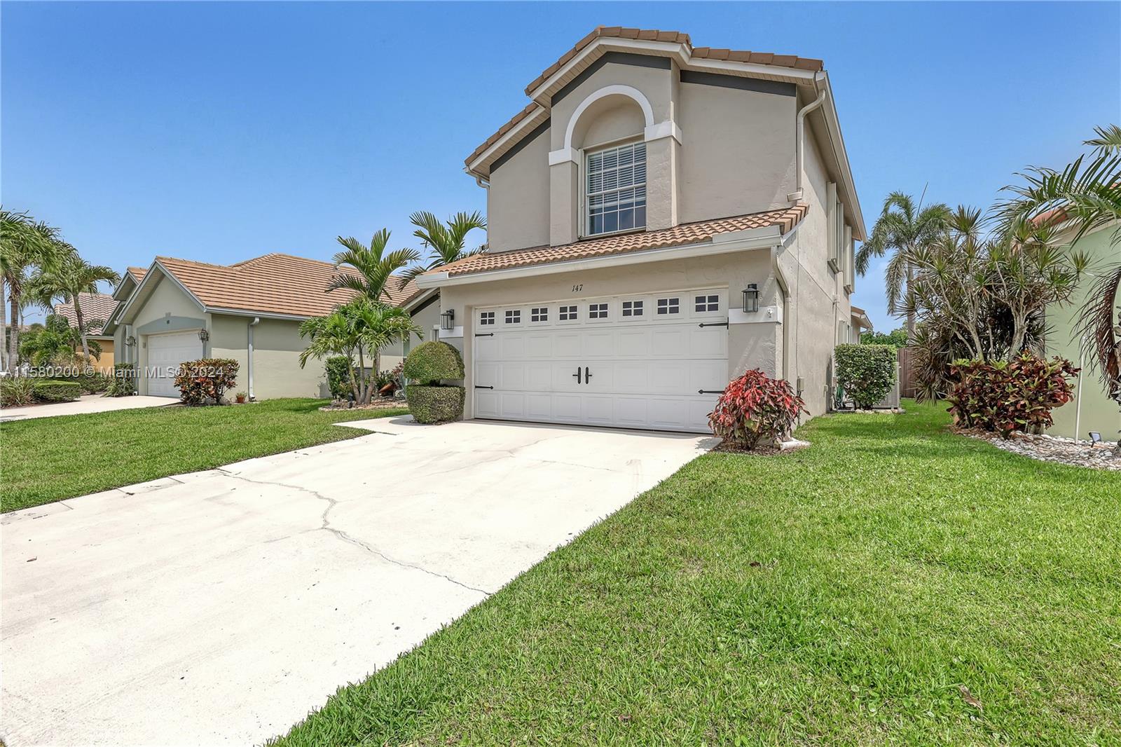 147 Stonebriar Boulevard Jupiter, FL 33458 - Photo 4 of 39 a view of a house with a yard