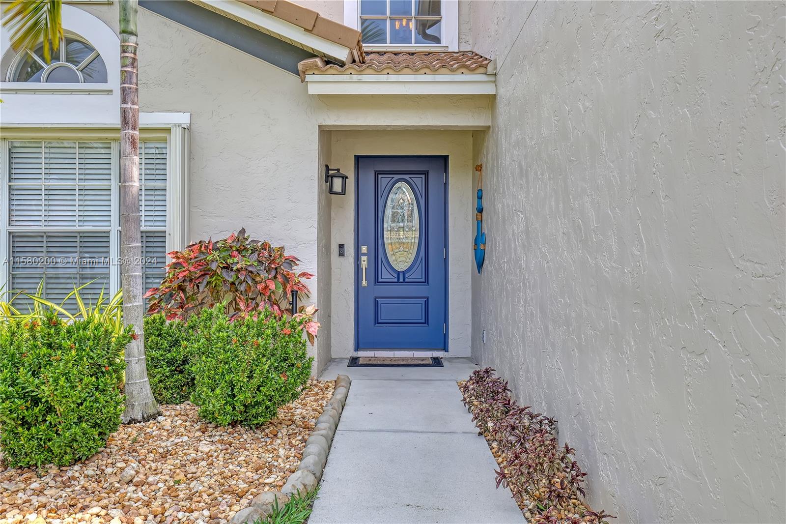 147 Stonebriar Boulevard Jupiter, FL 33458 - Photo 5 of 39 a front view of a house with garden